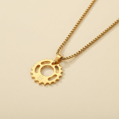 Gold gear-shaped pendant on a chain