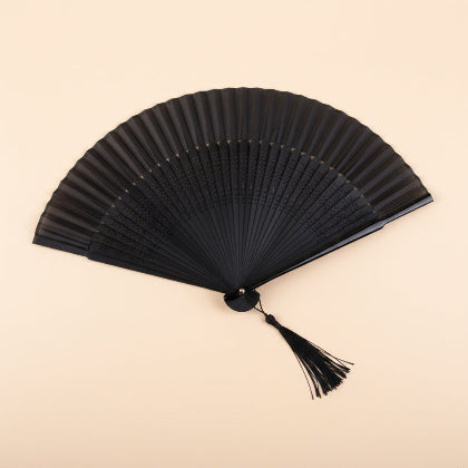 Black folding fan with a tassel