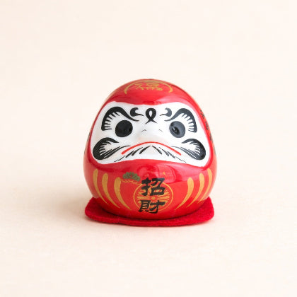 Red Daruma doll with black eyes and white face