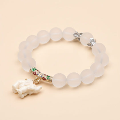 White beaded bracelet with an elephant charm